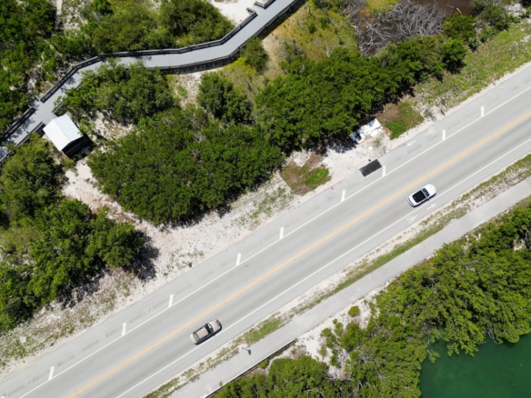 an aerial view of a road and a river